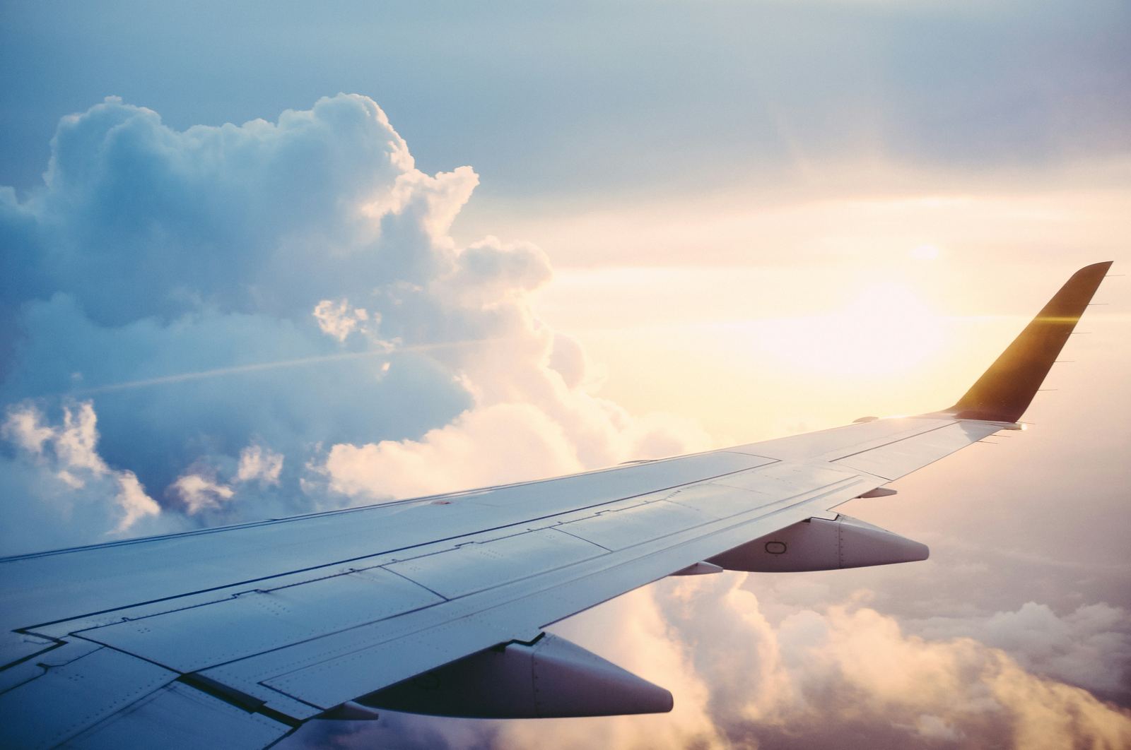 View of an airplane wing above the clouds
